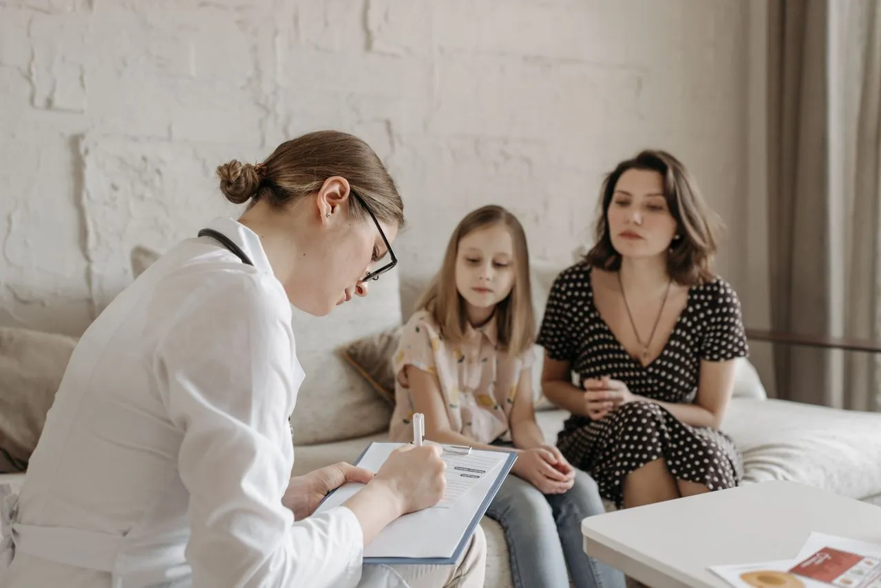 Doctor consulting with family at Ample Primary Care West Hartford CT